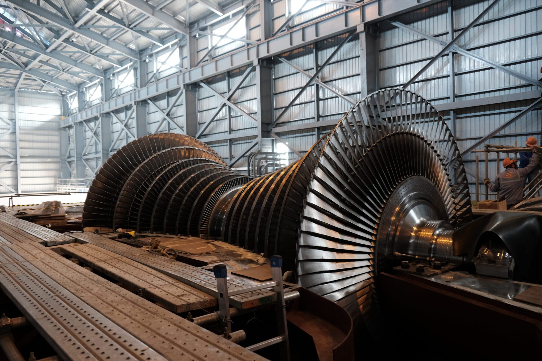 Large industrial steam turbine under assembly inside a metal-structured facility